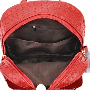 Detail view of red faux leather backpack interior with zipper pocket and compartments