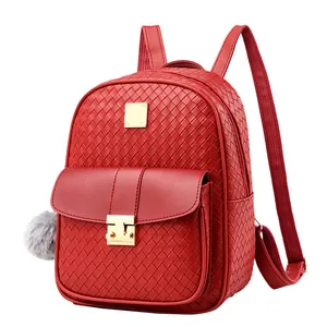 Detail of red embossed PU leather backpack featuring woven texture and gold metal buckle