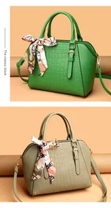 Detail of crocodile pattern handbags in green and khaki with decorative silk scarves