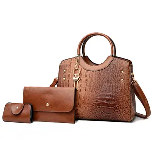 Brown crocodile embossed tote bag set with three pieces and metallic rivet details