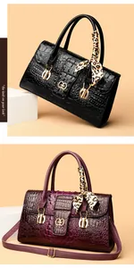 Detail view of crocodile pattern handbags with leopard scarves and golden buckle