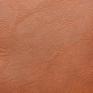 Macro shot of caramel brown pebble grain PU leather texture on retro women backpack