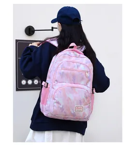 Detail of pink camouflage backpack featuring durable mesh side pockets and adjustable straps
