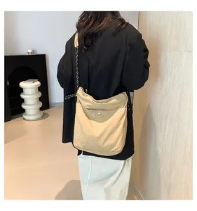 Rear view of khaki nylon crossbody bag with stylish woven rope strap on model