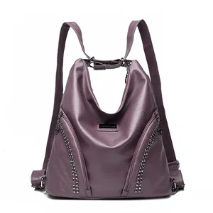 Purple faux leather backpack with studded zippers and versatile shoulder strap style