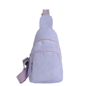 Detailed close-up showing the soft corduroy texture and metal zipper of the lavender crossbody bag
