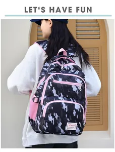 Outdoor shot of camouflage kids backpack with pink trim and mesh side pocket