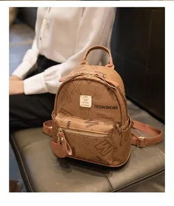 Brown mini PU leather backpack with monogram print and metal plaque details