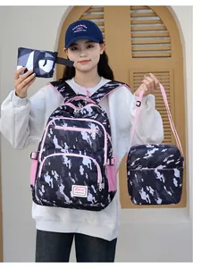 Macro view of camo backpack set with pink straps and multi-pocket detail shown by model