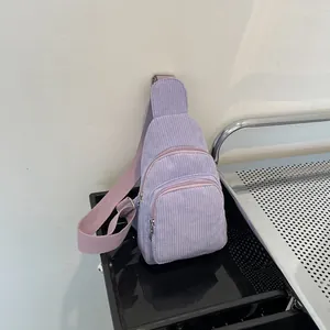 Minimalist light purple corduroy crossbody fanny pack with adjustable strap on white background