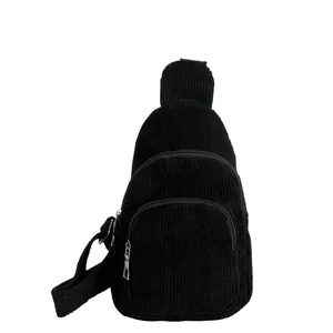 Minimalist black corduroy chest bag with multi-zipper compartments and adjustable strap