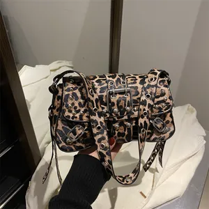 Leopard print punk shoulder bag with silver metal studs and grommet belt strap details