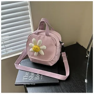 Close-up of pink canvas bag featuring a 3D white daisy with a smiley face detail