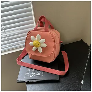 Detail of coral pink canvas mini bag with white corduroy daisy and smile face