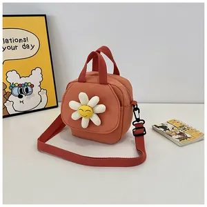 Detail of cute orange canvas mini bag with 3D daisy flower and adjustable strap