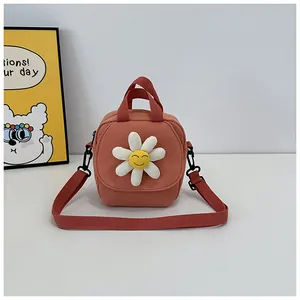 Detailed view of pink canvas crossbody bag with white daisy flower and smiley face design