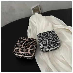Detailansicht quadratischer Schmuckschatullen mit Leopardenmuster aus Leder in Braun und Grau