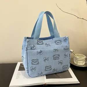Blaue Cord-Lunchtasche mit Cartoon-Bär-Druck und praktischer Vordertasche