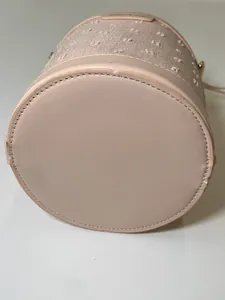 Detail view of pink bucket bag base showing premium stitching and textured fabric