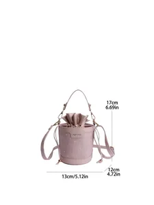 Pink drawstring bucket bag detail with golden hardware and adjustable shoulder strap