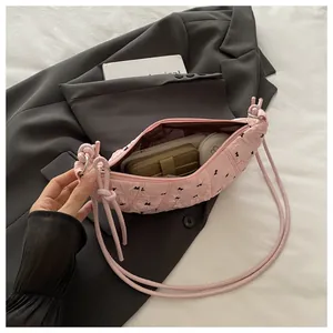 Detailed interior view of a pink quilted bag with bow patterns and zipper closure