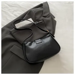 Detail of a chic black sequined baguette bag with buckle on a professional blazer