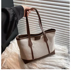 Detail of the high-quality canvas and leather stitching on this retro tote handbag
