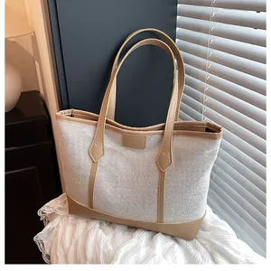 Detail of contrast stitch patchwork tote bag with woven mesh fabric and leather straps