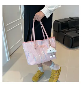 Detail of pink tote bag featuring pleated texture, colorful wavy embroidery and cloud charm