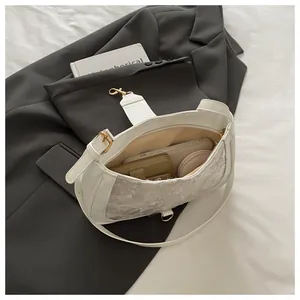 Top view of white lace shoulder bag showing interior space for phone and wallet