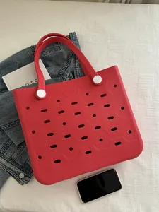 Detailaufnahme der roten EVA-Strandtasche mit Wabenlöchern und weißen Befestigungen