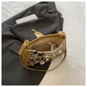 Detail of sequined baguette bag interior showing capacity for phone and cosmetics