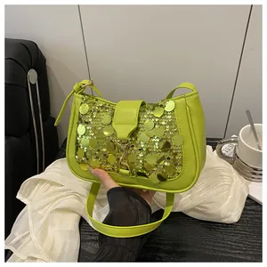 Detail of lime green sequined shoulder bag with metallic clasp and premium leather strap