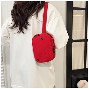 Detailed back view of a red nylon crossbody bag showing wide strap and comfort fit