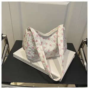 Close-up of pink bow print on white pleated fabric with a sturdy beige zipper detail