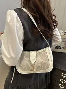 White sequined half-moon shoulder bag with gold metal clasp and adjustable strap
