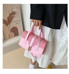 Detail of pink woven texture and smooth leather finish on a stylish handbag with clasp