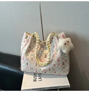 Detail showing bubble texture fabric tote bag with floral bear prints and woven handle