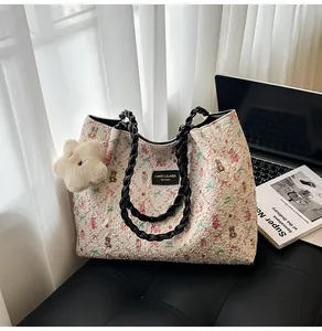 Detail of cute bear printed pleated canvas tote bag with black woven handles and star charm