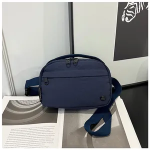 Detailed view of the dark blue nylon crossbody bag with LANWEIER woven label and strap