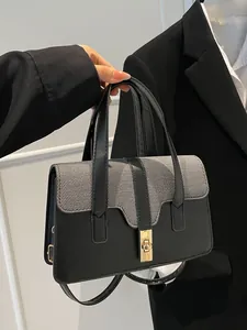 Chic black patchwork shoulder bag with textured weave and gold buckle for women