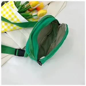 Detailed interior of green nylon crossbody bag showing spacious main compartment and zipper
