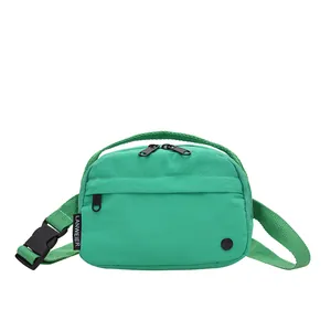 Minimalist mint green nylon crossbody bag with dual zipper pockets and adjustable strap