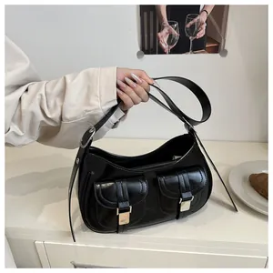 Detail of black Hobo underarm bag with silver buckles and adjustable shoulder strap