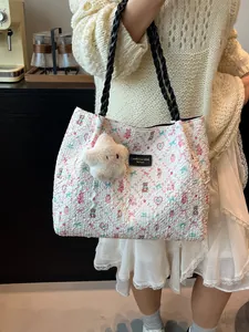 Minimalist white quilted tote bag with pink bear patterns and star plush charm accessory