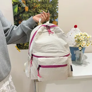 Detail of minimalist nylon travel backpack with vibrant pink contrast zippers
