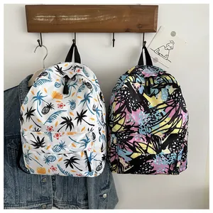 Detail of colorful graffiti school backpacks in white and black with abstract floral prints