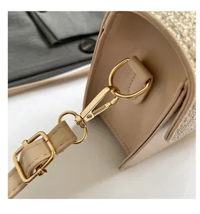 Detailed macro view of apricot leather bag with gold glitter side and metal buckle
