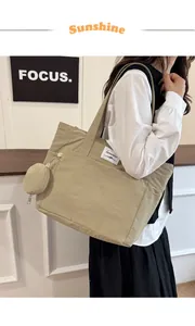 Detail of khaki nylon tote bag with small coin purse showing large capacity and texture