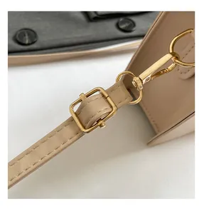 Detail of adjustable leather strap with golden metal lobster clasp and fine stitching